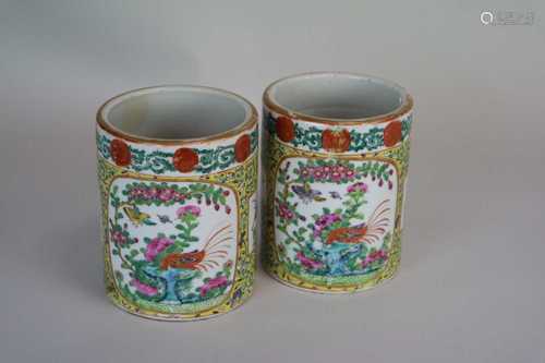 A pair of Cantonese famille rose cylindrical vases, with yellow ground, decorated with vignettes