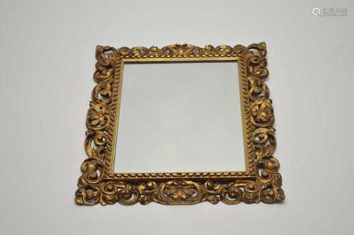 A Florentine type framed wall mirror, with pierced scrolling foliate frame, 59 x 49cm (total).