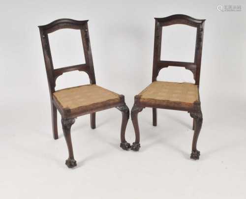 A set of six mahogany dining chairs, with scrolling shallow carved backs, the swept claw and ball