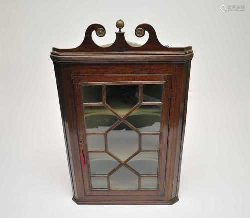 A 19th century glazed-front oak wall-hanging corner cupboard, with a painted shelved interior, 117 x