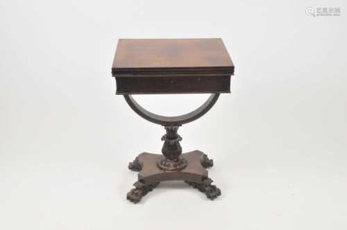 A small 19th century mahogany card table, with a slide folding top, over a carved stem and