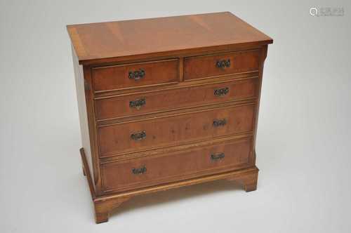 A yew veneered chest of two short and three long drawers, raised on bracket supports, 73cm high,