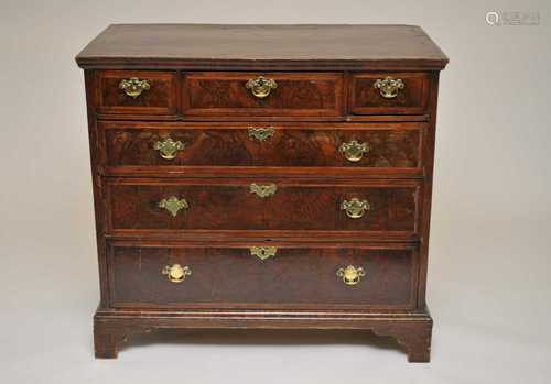 A 19th century mahogany chest of drawers, the over-hanging top with strung inlaid borders above a