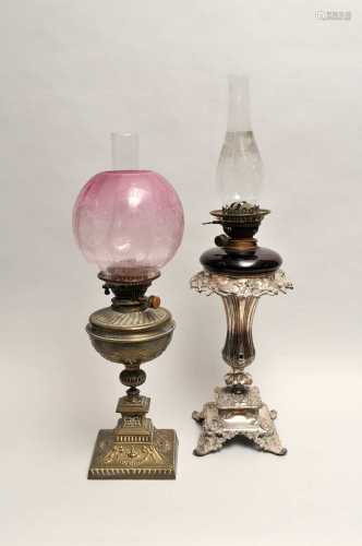 A Victorian electroplated lamp stand, accommodating a ruby glass oil lamp, with clear glass chimney,