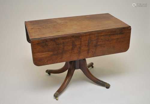 A 19th century mahogany sofa table, raised on four swept legs, with brass caps and castors, 71cm