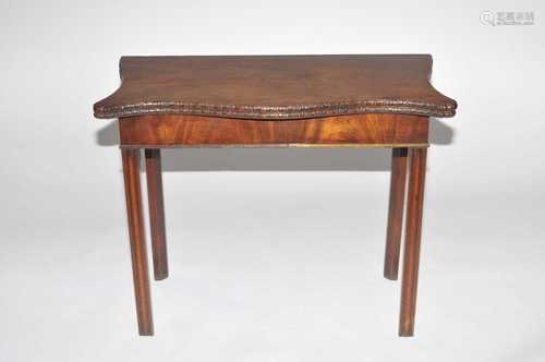 A 19th century serpentine mahogany card table, with floral carved borders and green felt-lined