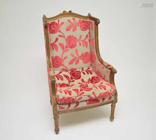 An early 20th century French gilt armchair, the carved frame decorated with acanthus mounts,