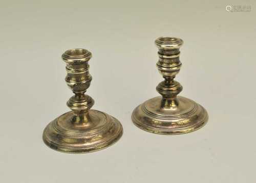 A pair of short silver mounted candlesticks