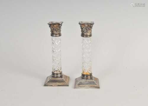 A pair of silver mounted glass candlesticks