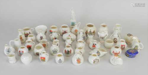 An assorted collection of crested ware comprising examples by Arcadian, Carlton, Goss and Shelley,