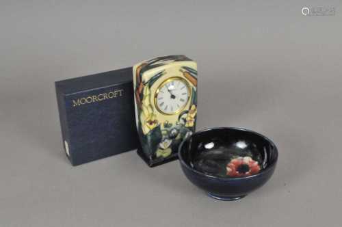 A Moorcroft mantel timepiece in the 'Lamia' pattern, 15cm high (boxed) together with a small