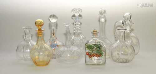 An interesting selection of glass decanters, including a wrythen amber moulded example, cut, press-