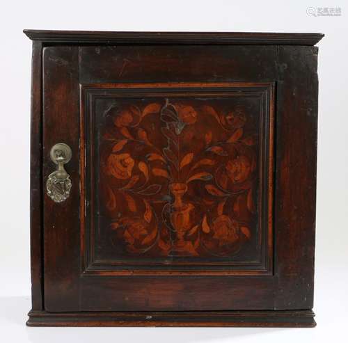 17th Century oak and inlaid spice cupboard, the rectangular cupboard with a square panelled door