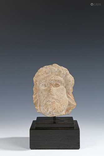 Medieval limestone head, 14th Century, the small size head with long hair and a beard, 13cm high