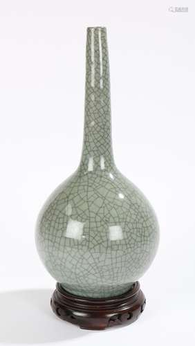 Chinese crackle glaze celadon bottle vase, on a hard wood stand, 27cm high excluding the stand