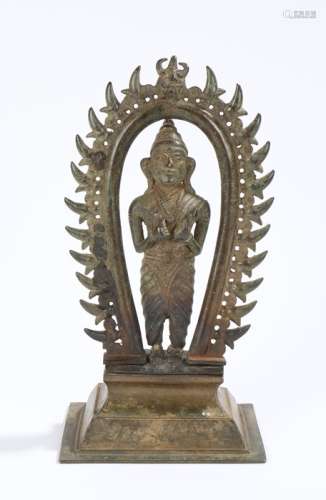Indian bronze deity, the figure standing under an arched frame, 27cm high