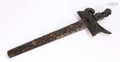 Indonesian Kris, the carved grip and scabbard depicting masks, 54.5cm long