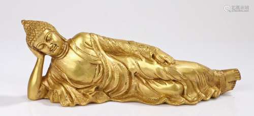 Bronze Buddha, the gilt Buddha in a reclining position, 30cm long