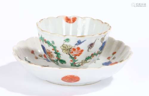 Chinese porcelain famille verte tea bowl and saucer, Kangxi, with a branch and projecting flowers,
