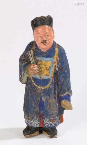 Chinese pottery figure, Qing Dynasty, of a standing man with blue robes and clutching a fan, 15cm