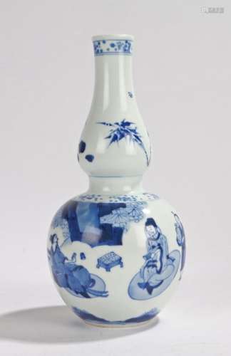 Chinese double gourd vase, in blue and white with figures seated playing games with further