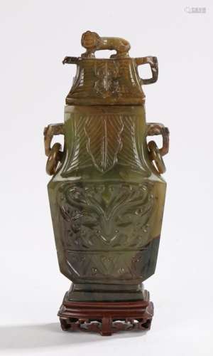 Chinese jade vase and cover, the cover with a lion above elephant mask handles holding loops, the
