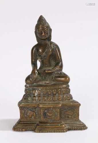 Chinese bronze buddha, seated position above a steeped base, 12cm high
