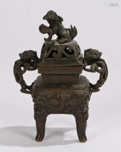 Chinese bronze censor, Qing dynasty, with a dog of foo above a scroll top flanked by arched masks