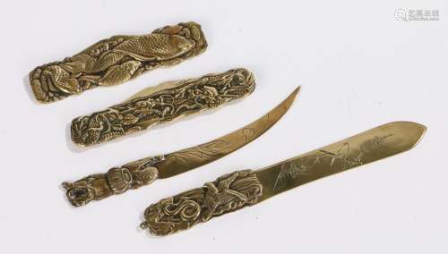 Japanese brass objects, to include two folding knives and two small letter openers, (4)