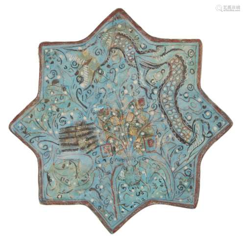 An Ilkhanid Ladjvardina moulded pottery star tile, Iran, late 13th century, moulded under the
