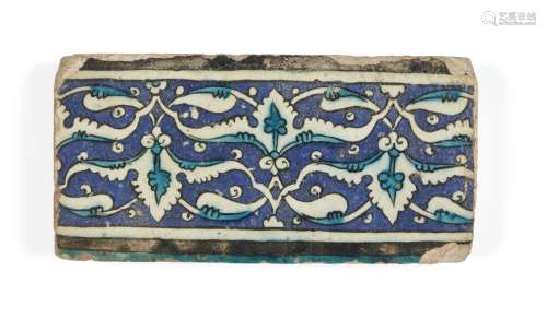 A Damascus Iznik border tile, 16th century, of rectangular form, the cobalt ground decorated in