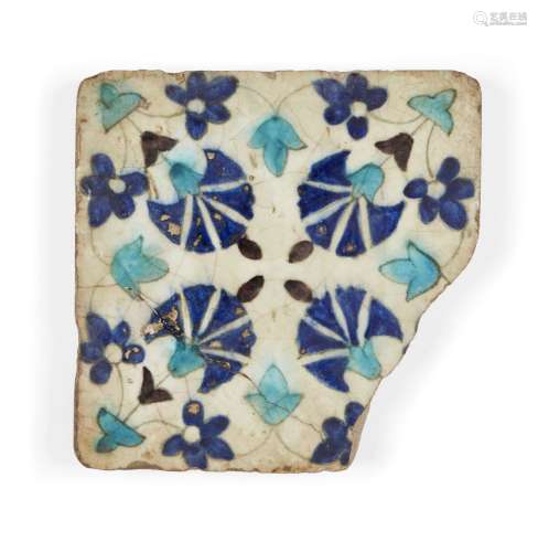 A Damascus Iznik tile fragment, 17th century, formerly of square form, the white ground decorated in