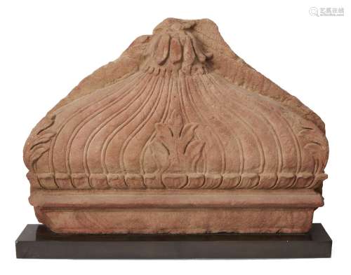 A red sandstone fragment of a dome, Mughal India, 17th century, carved with a lotus flower to top,