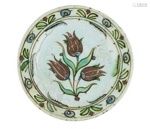 An Iznik pottery bowl, Turkey, early 17th century, of shallow form, underglaze painted with a