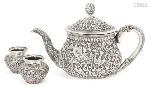 A silver repousse Kutch teapot, India, circa 1860 and two silver spice containers, of squat form