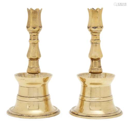 A pair of Ottoman brass tulip candlesticks, Turkey, 17th/18th century, each rising from a conical
