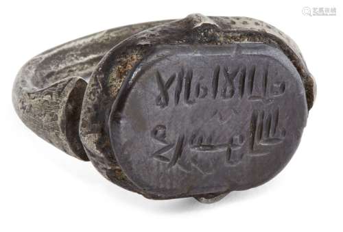 A hematite inscribed ring, Iran, 11th-12th century, the bezel of oval form with two lines of kufic