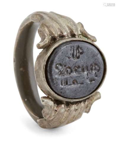 A hematite Kufic inscribed ring, Iran, 12th century and later, the white metal bezel set with the