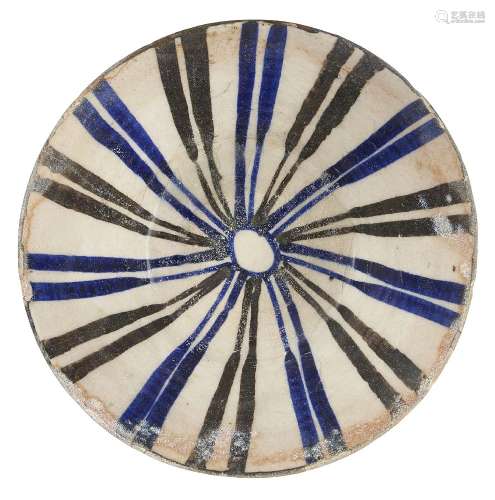A Kashan blue, black and white conical pottery bowl, Central Iran, 13th century, on vertical foot,