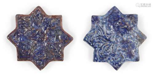 Two Ilkhanid Ladjvardina moulded pottery star tiles, Iran, late 13th century, moulded under the