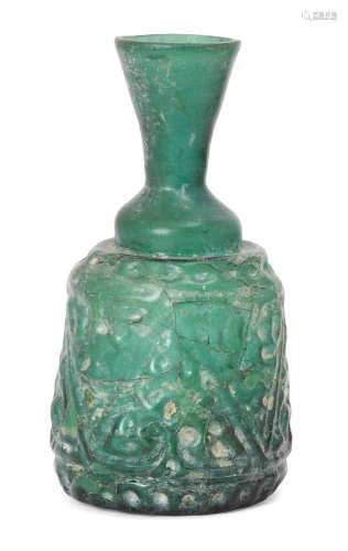 A Qarakhanid glass bottle, Central Asia, 11th-12th century, of dome-shaped form, flared neck,