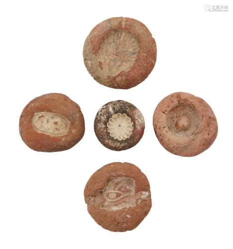 Five Egyptian terracotta bead and ring moulds, Amarna Period, 14th century BC., largest 3.7cm. diam.