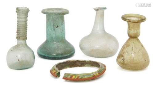 Four small Roman glass vessels, circa 2nd-4th century AD., including a pale blue spherical-bodied