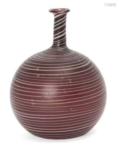 A Phoenecian trailed aubergine glass flask, 2nd-3rd century AD, of bottle for, with tall thin neck