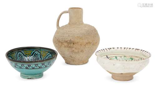 Three Islamic pottery vessels, including an unglazed and stamped handled vase, an incised green