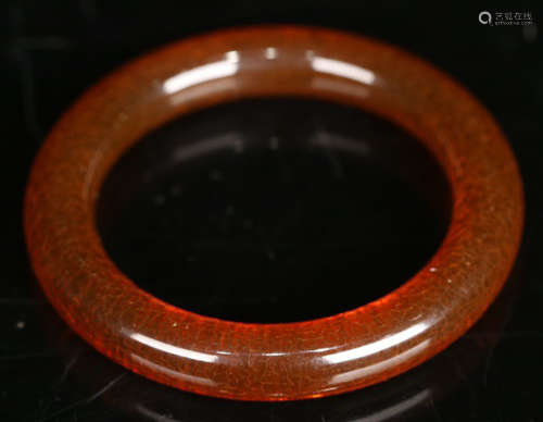 AN AMBER CARVED BANGLE