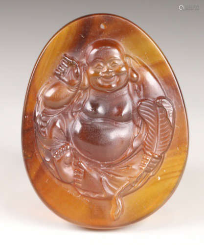 AN OLD AMBER TABLET CARVED WITH MAITREYA BUDDHA