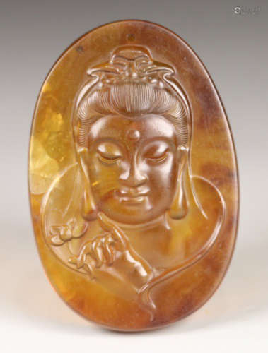 AN OLD AMBER TABLET CARVED WITH GUANYIN BUDDHA