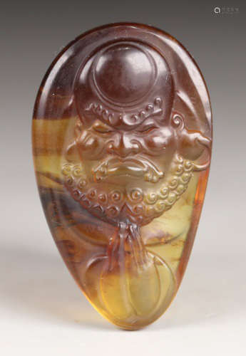 AN OLD AMBER TABLET CARVED WITH BODHIDHARMA