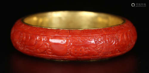 A CORAL BANGLE CARVED WITH BEAST PATTERN